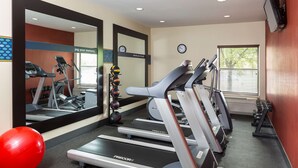 A gym with treadmills, exercise balls, and a mirror. - Hampton Inn Zanesville (Zanesville)