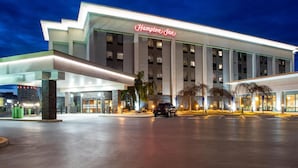 A modern Hampton Inn hotel with a prominent entrance, large windows, and a well-lit facade. - Hampton Inn Williamsport-Downtown (Williamsport)