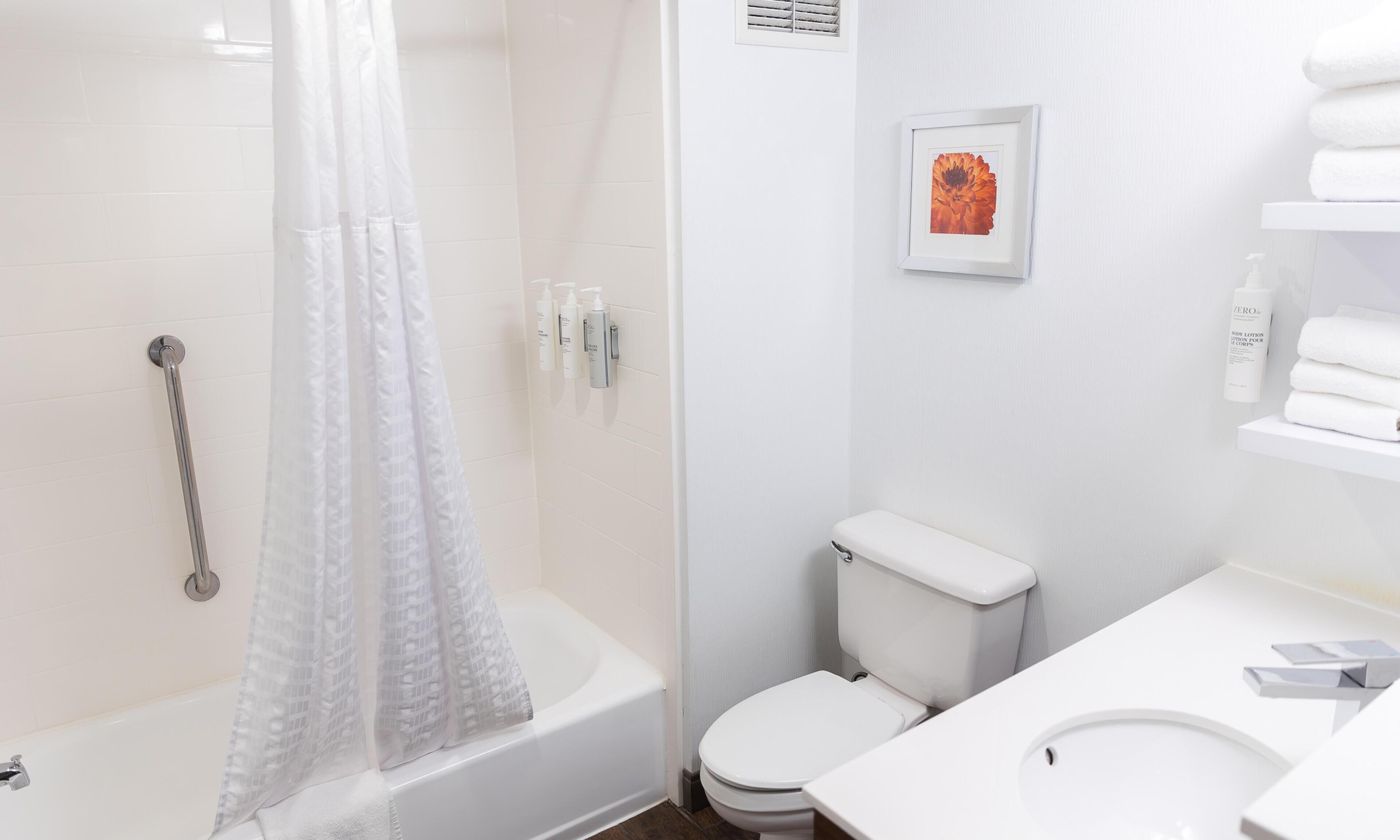 A bathroom with a shower, toilet, and sink.