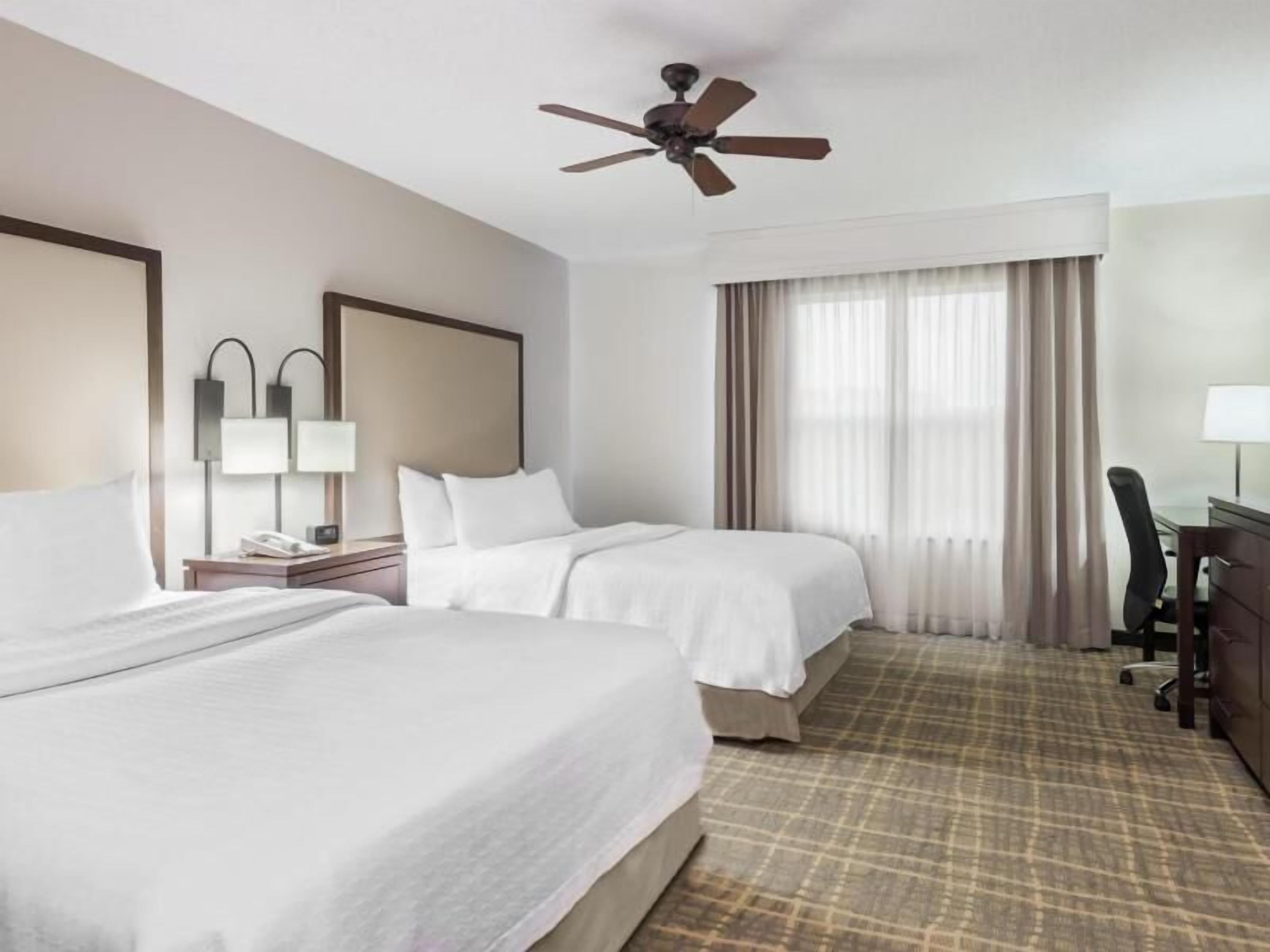 Hypo-allergenic bedding, desk, laptop workspace, blackout drapes