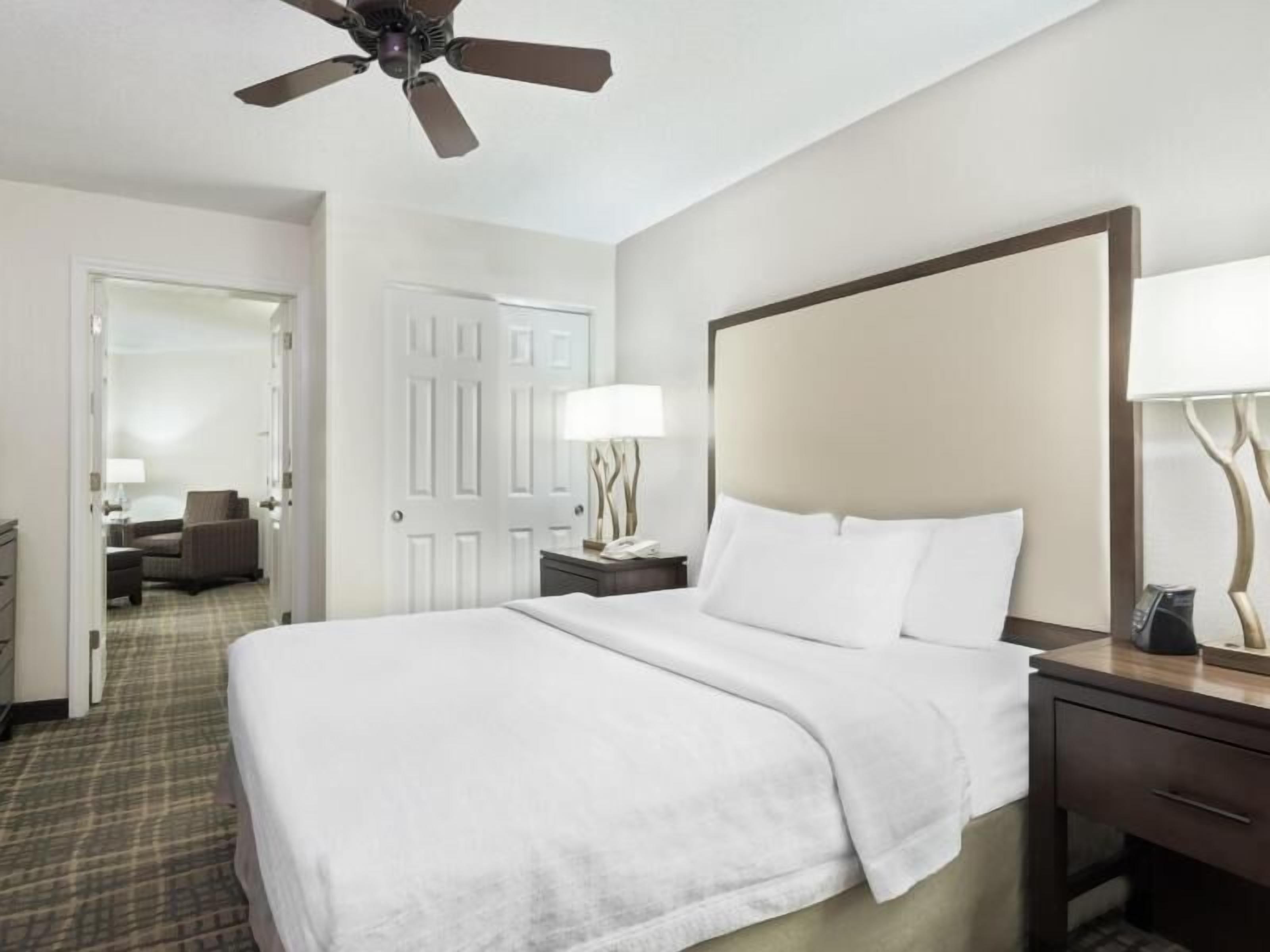 Hypo-allergenic bedding, desk, laptop workspace, blackout drapes