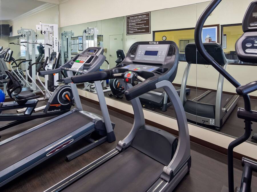 A gym with treadmills, exercise balls, and weight machines.