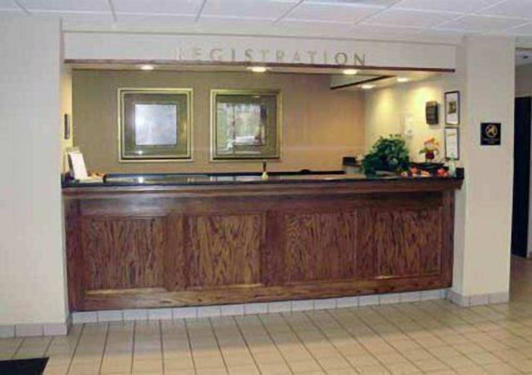 A reception desk with a wooden finish and a sign that reads "Registration".