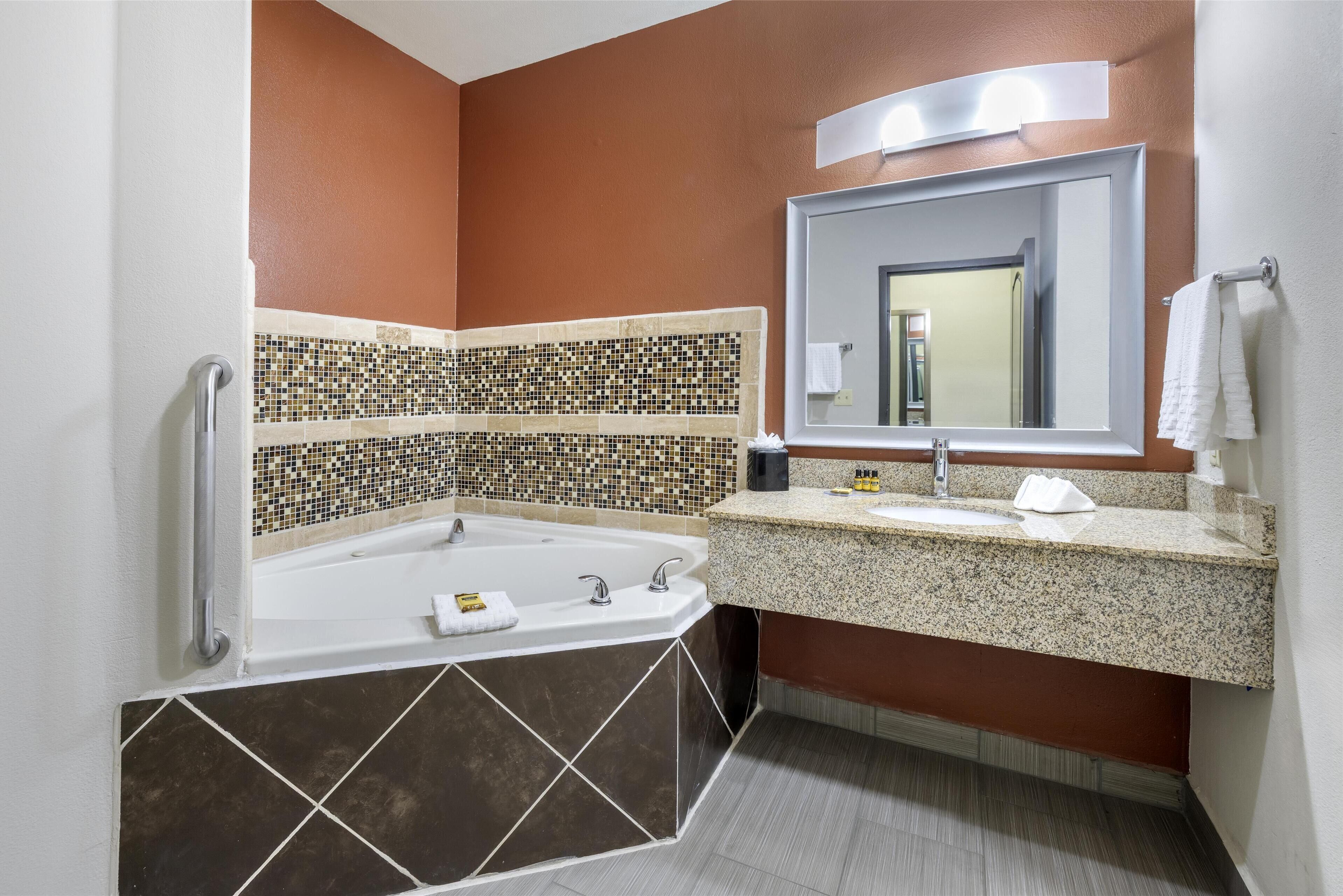 suite, 1 king bed, jetted tub | bathroom | combined shower/bathtub, free toiletries, hair dryer, towels