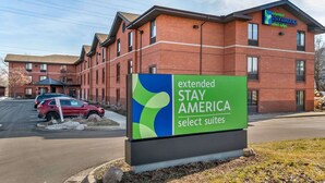 Een gebouw van baksteen met een bord voor Extended Stay America Select Suites.