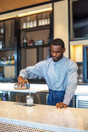 A bartender pouring a drink into a glass. - Hyatt Place Colorado Springs/Garden of the Gods (Colorado Springs)