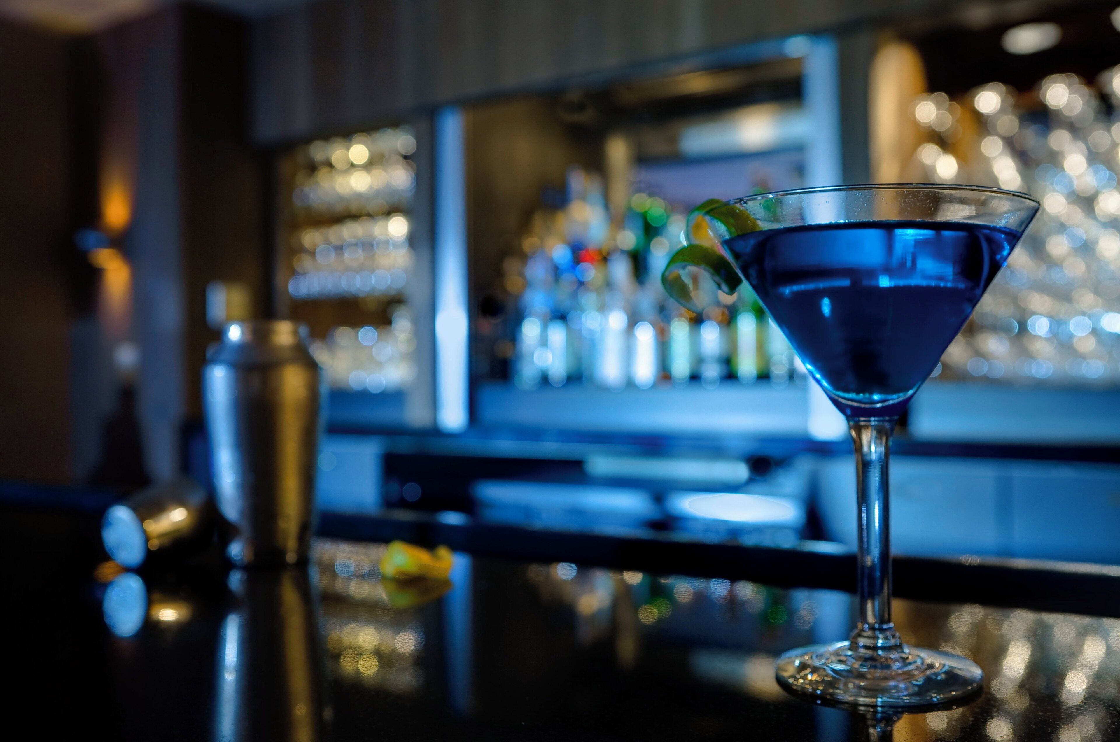 A bar setting with a martini glass on the counter.