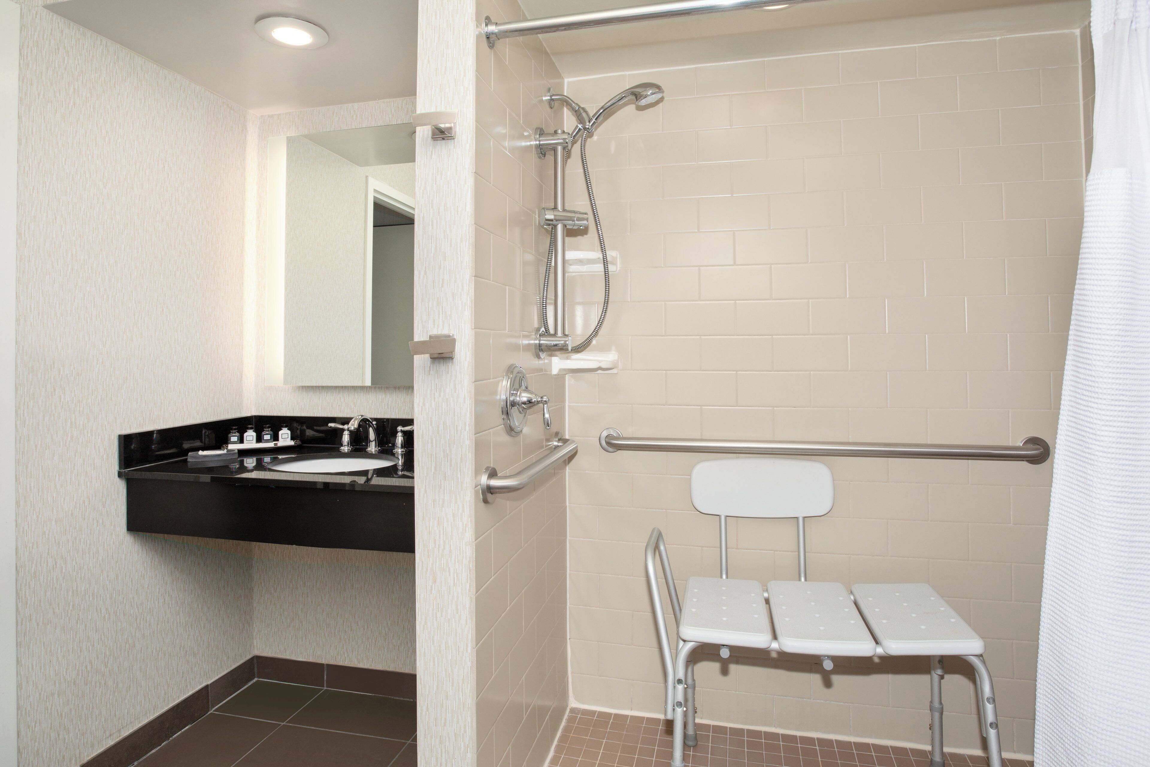 A bathroom with a shower, a toilet, and a sink.