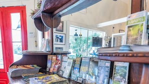 A wooden counter with magazines and a mirror. - Historic Mardi Gras Inn (New Orleans)