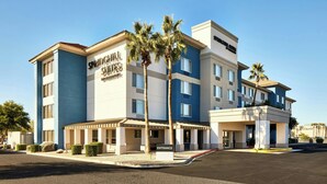A hotel with a modern design, featuring a prominent entrance and multiple floors.