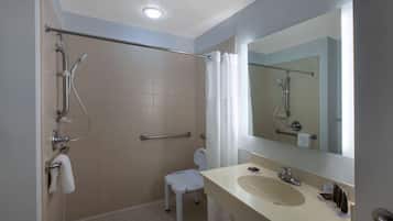 A bathroom with a shower, toilet, and sink.
