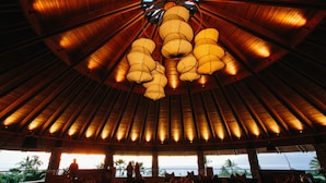 A spacious indoor area with a high ceiling, large windows, and a view of the ocean. - Hotel Wailea, Relais & Chateaux - Adults Only (Kihei)