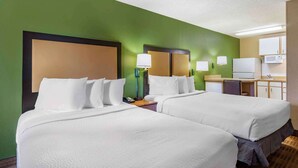 A hotel room with two beds, a desk, a microwave, and a small kitchenette. - Extended Stay America Select Suites Tampa North Airport (Tampa)