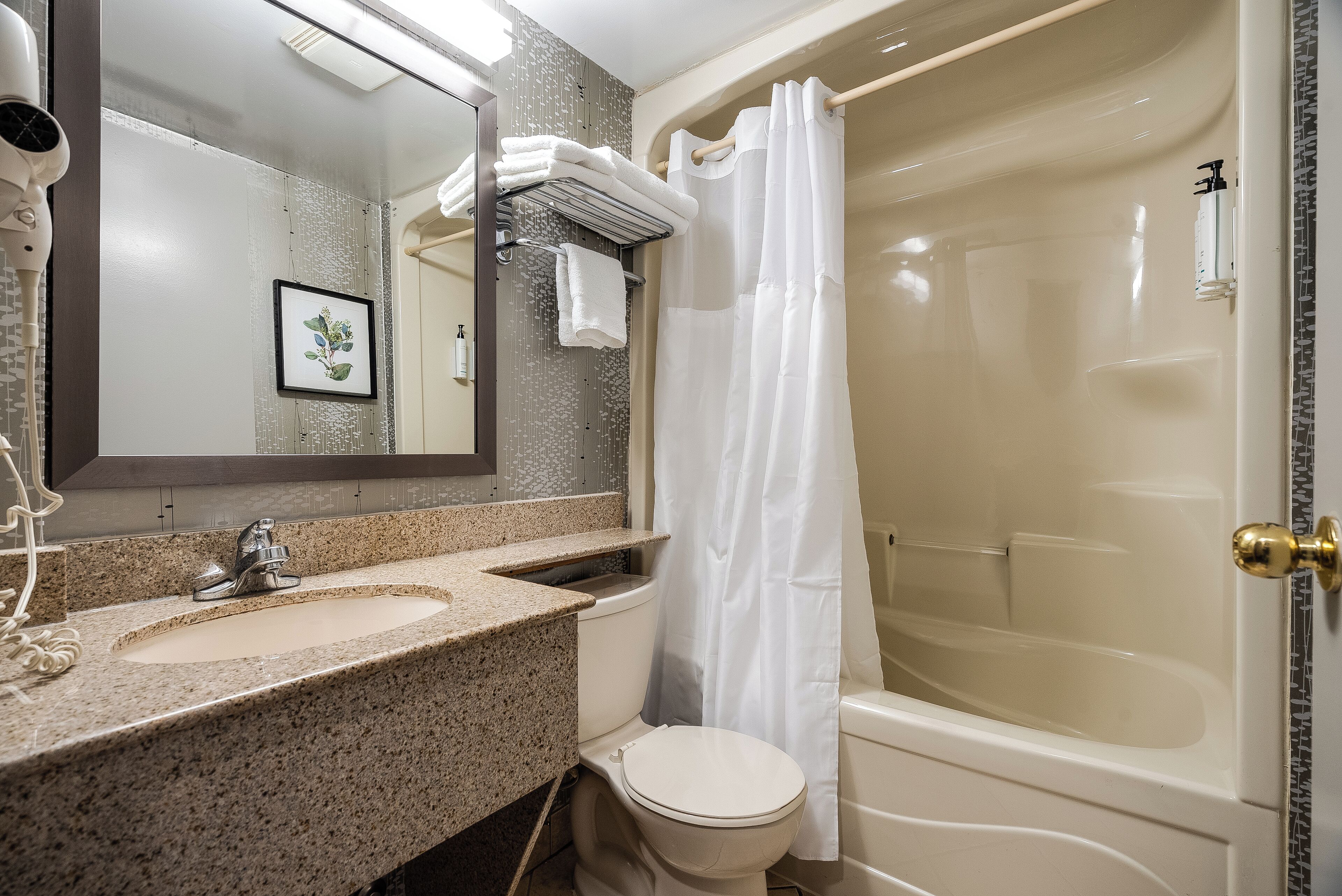 Un baño con lavamanos, inodoro y bañera.
