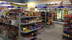 A grocery store with sections for frozen foods, juices, meat & dairy, bottled water, carbonated drinks, and energy drinks. - Petawawa River Inn and Suites (Petawawa)