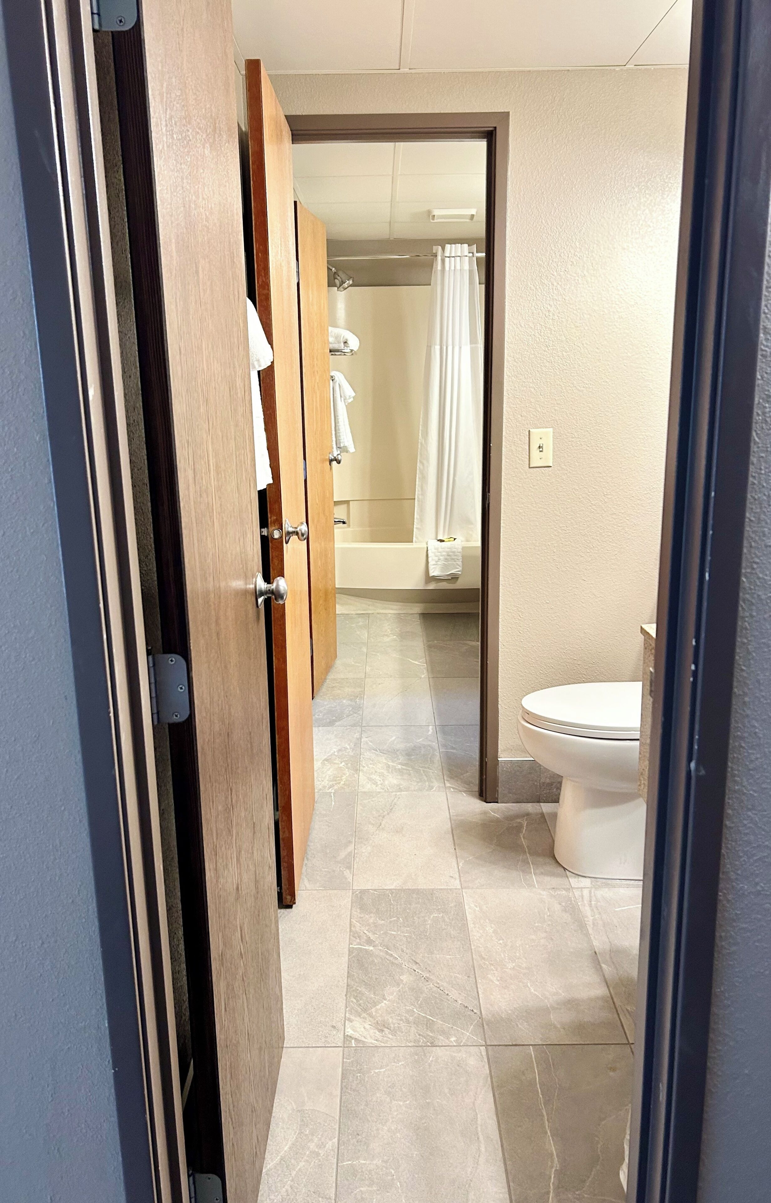 A bathroom with a toilet, a shower, and a bathtub.