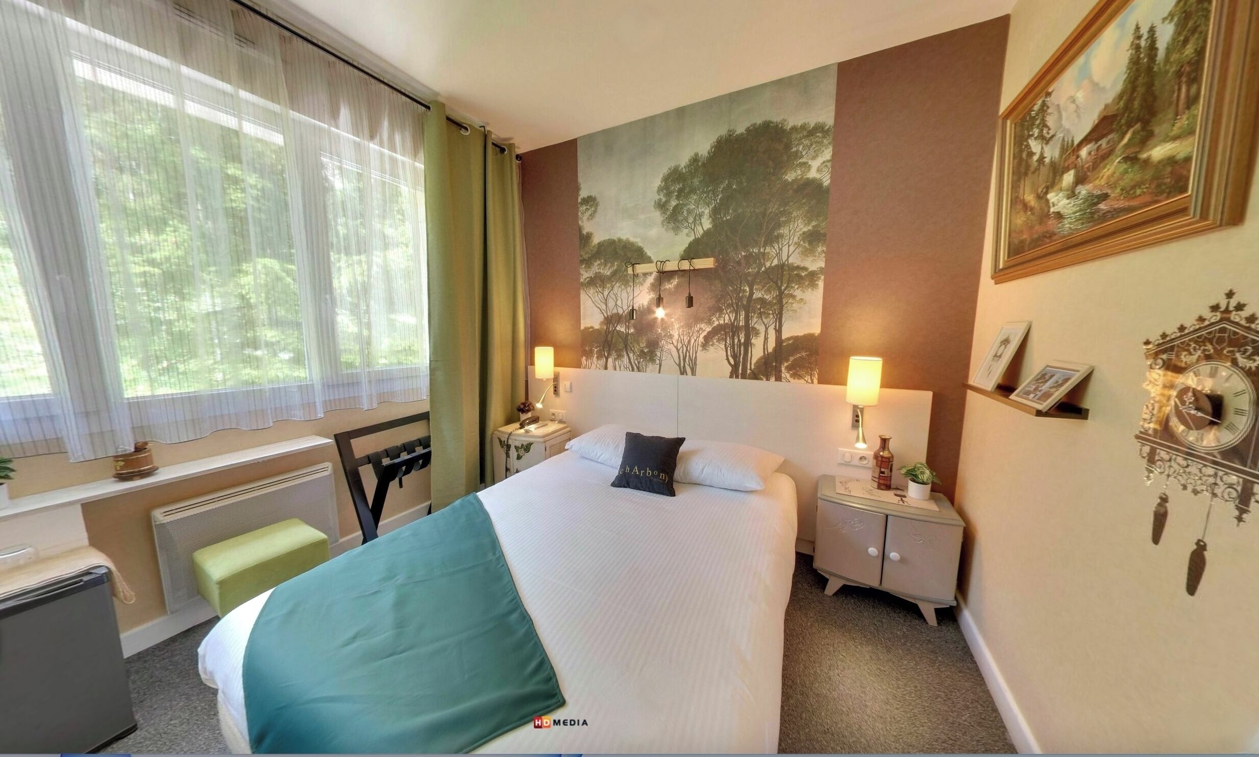 A hotel room with a bed, two bedside tables, a desk, a chair, a radiator, and a window with curtains.