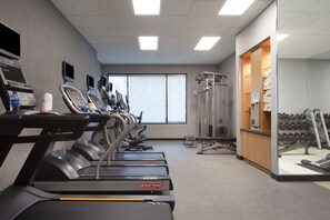A gym with treadmills, weight machines, and dumbbells. - Courtyard by Marriott Newark Silicon Valley (Newark)