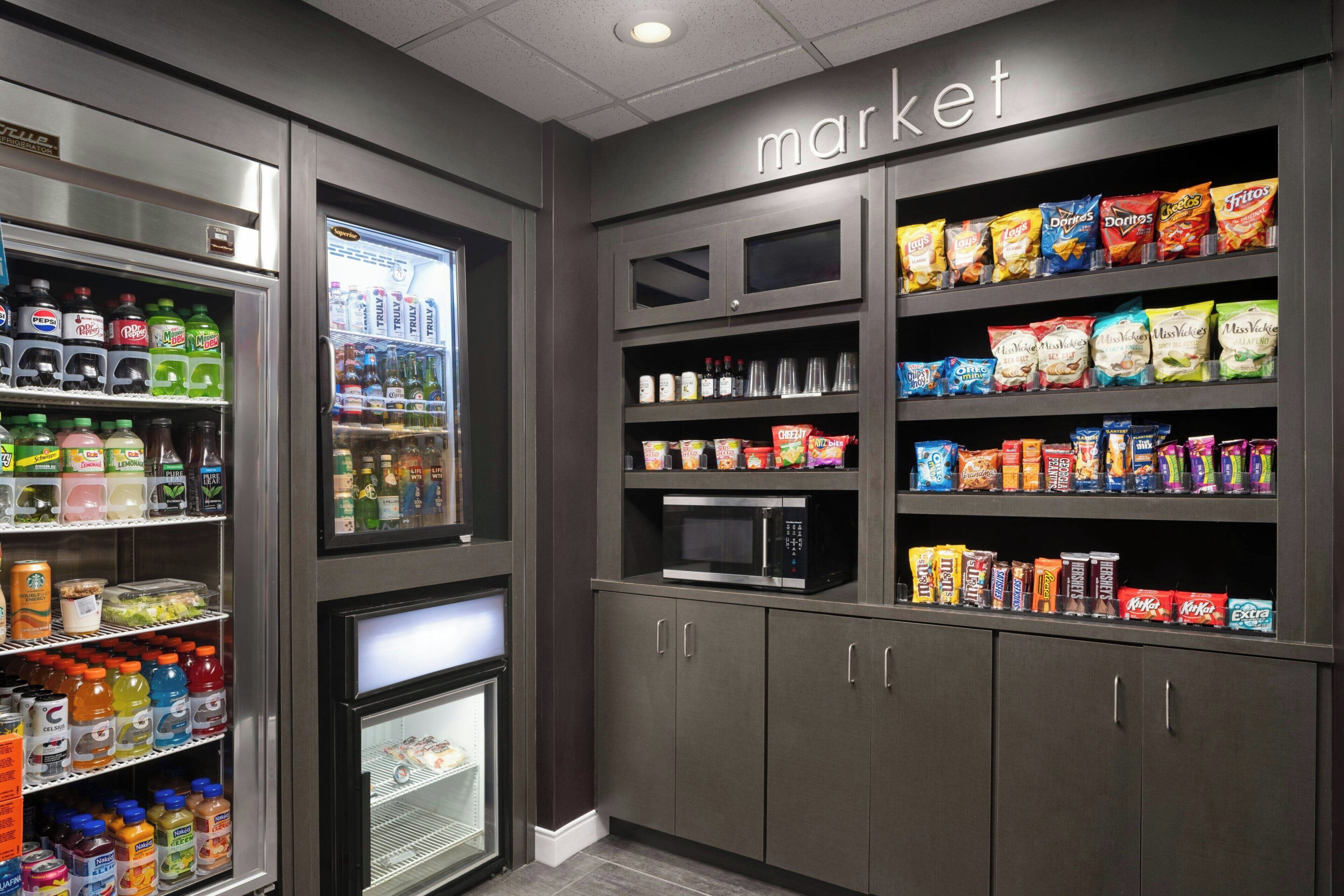 A vending machine area with snacks and beverages, a microwave, and a refrigerator.