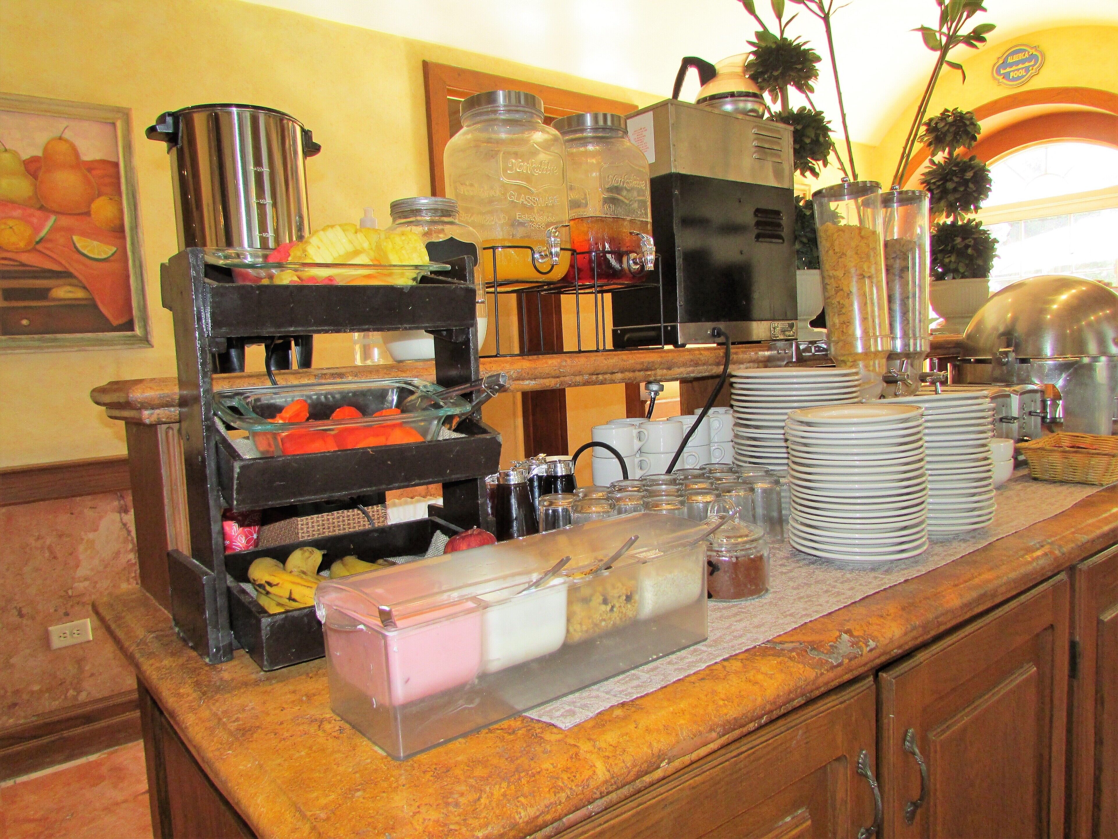 A buffet setup with various food items and condiments.