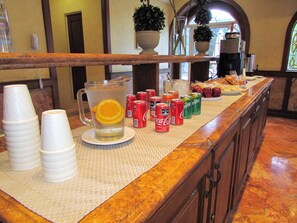 Enjoy a refreshing drink and snack at our bar, featuring a selection of beverages and fresh fruit.