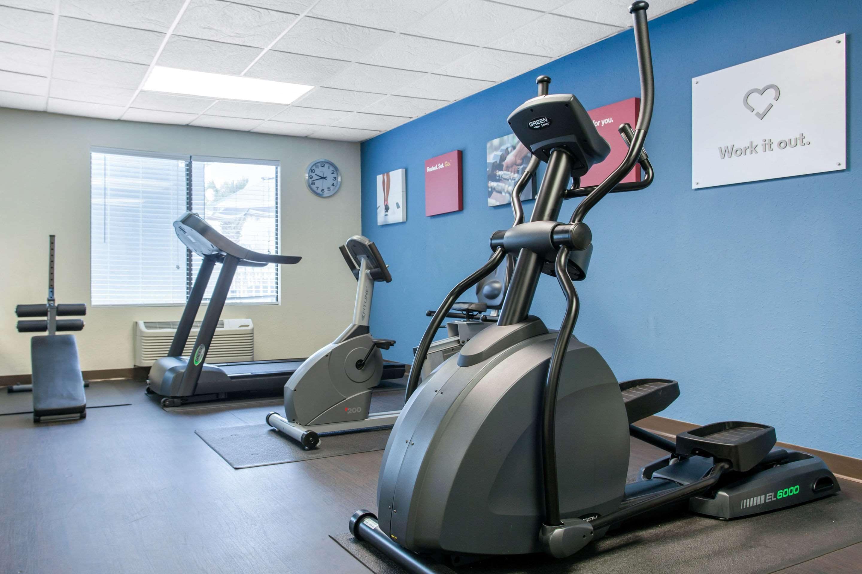 A gym with stationary bikes, a treadmill, and a rowing machine.