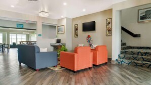 A hotel lobby with a breakfast area, seating with a TV, and a staircase. - Best Western Clare Hotel (Clare)
