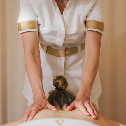 A person receiving a back massage.