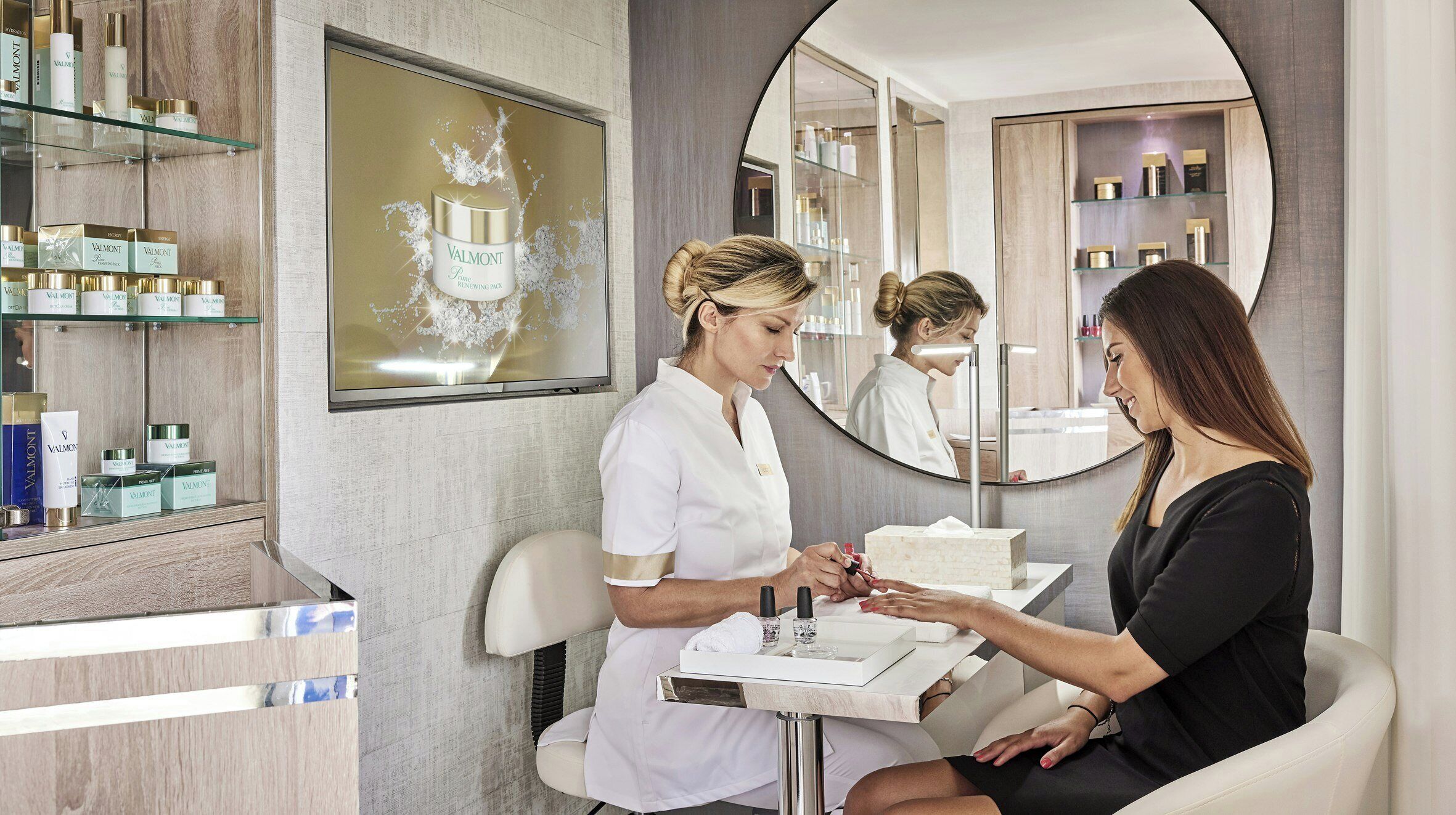 A salon interior with a reception desk, a large mirror, and shelves with various products.