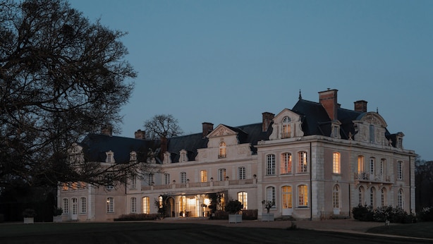 A large, historic building with multiple windows and a symmetrical facade.