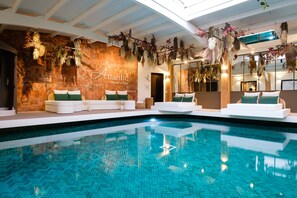 Indoor pool, open 10:30 AM to 7:00 PM, pool loungers