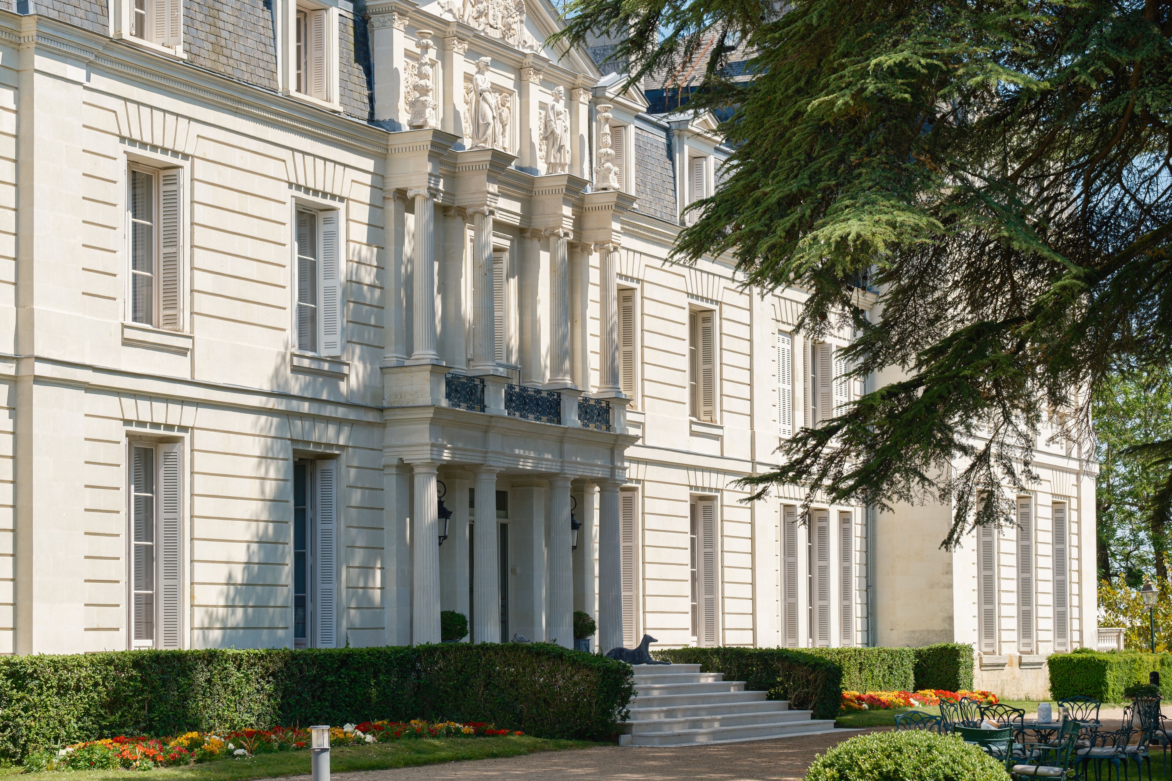 A grand building with classical architecture, featuring columns, a portico, and a symmetrical facade.