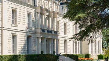 A grand building with classical architecture, featuring columns, a portico, and a symmetrical facade.