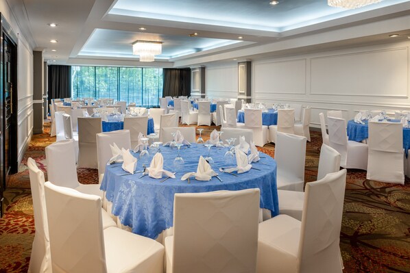 A banquet hall with round tables covered in blue tablecloths, surrounded by white chairs. - Crowne Plaza Panama by IHG (Panama City)