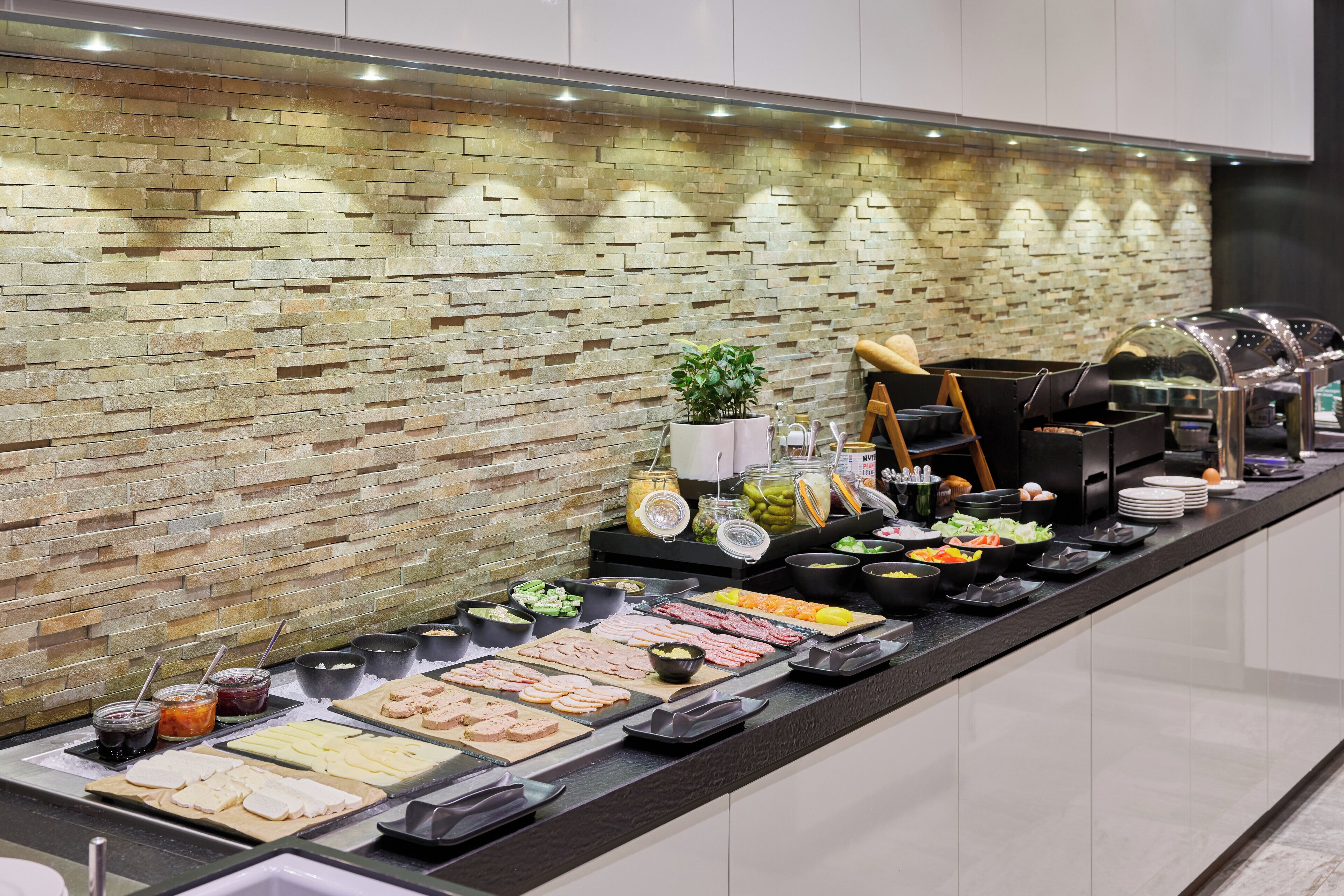 A buffet with various food items and condiments.