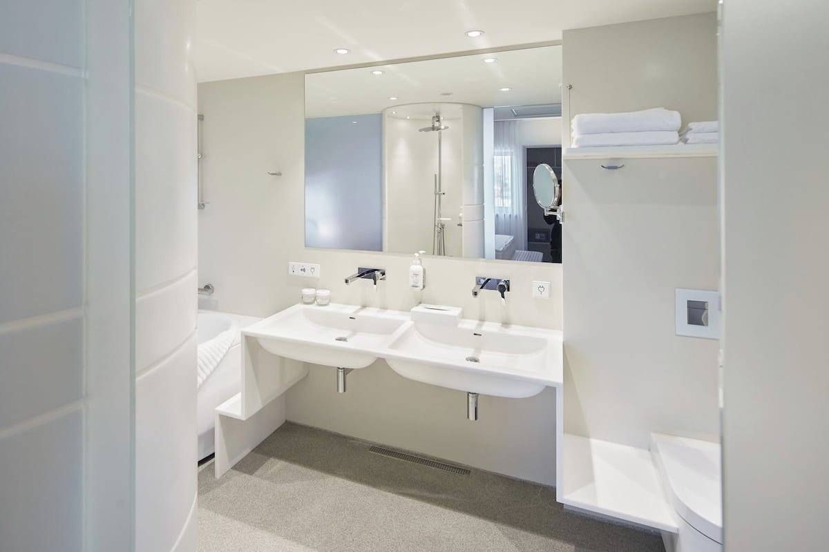 suite, 1 king bed (additional living area) | bathroom | rainfall showerhead, free toiletries, hair dryer, heated floors