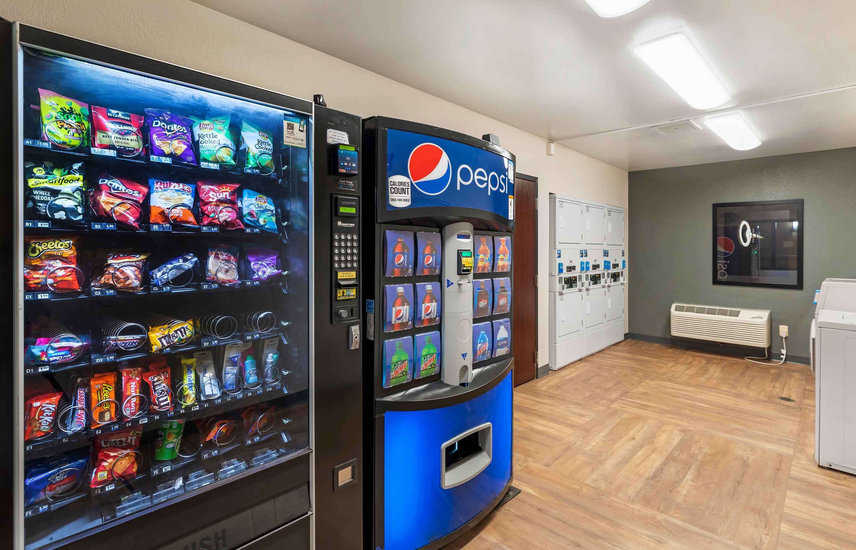 Alue, jossa on myyntiautomaatteja, joista saa pientä purtavaa ja juomia, mukaan lukien Pepsi-automaatti.