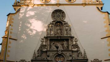A church with ornate architecture, including a large arched entrance and detailed sculptures.