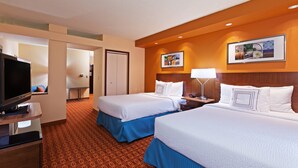 A hotel room with two beds, a TV, a desk, and a patterned carpet. - Fairfield Inn and Suites by Marriott Austin Northwest/Domain (Austin)