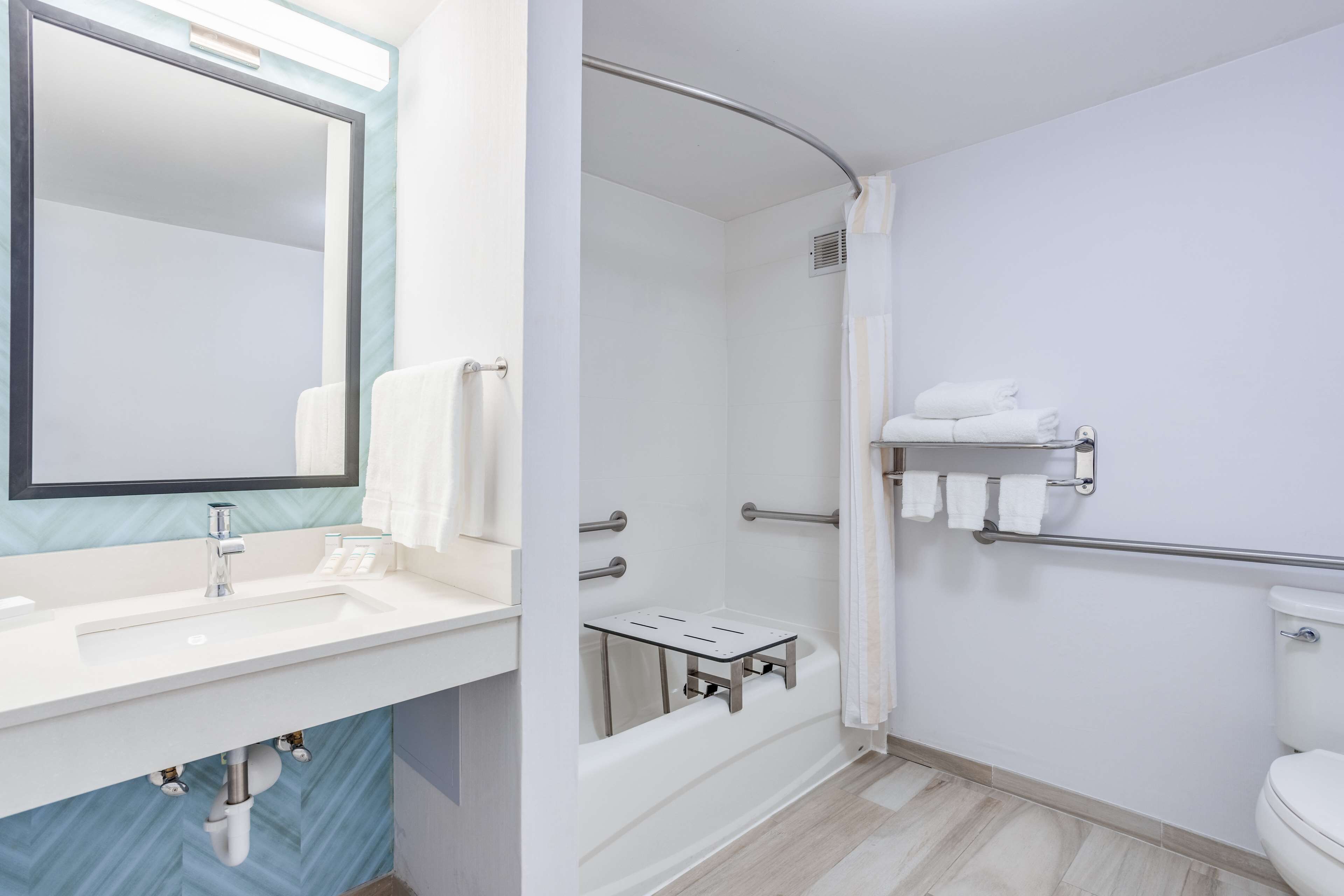 combined shower/bathtub, designer toiletries, hair dryer, towels