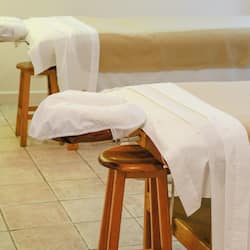 Relax and rejuvenate on one of our massage tables, set amidst a serene spa environment.