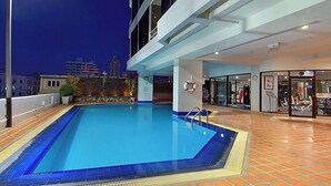 A rooftop pool with a clear view of the city skyline at night. - Tai Pan Hotel (Bangkok)
