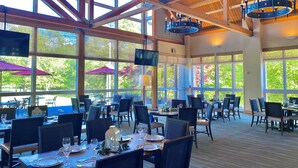 A spacious dining area with high ceilings, large windows, and modern chandeliers. - Hyatt Regency Chesapeake Bay (Cambridge)