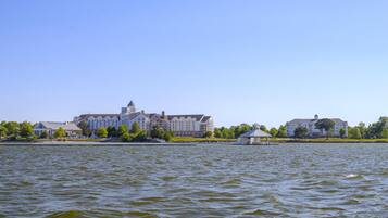 A waterfront property with a large building, a gazebo, and a body of water.