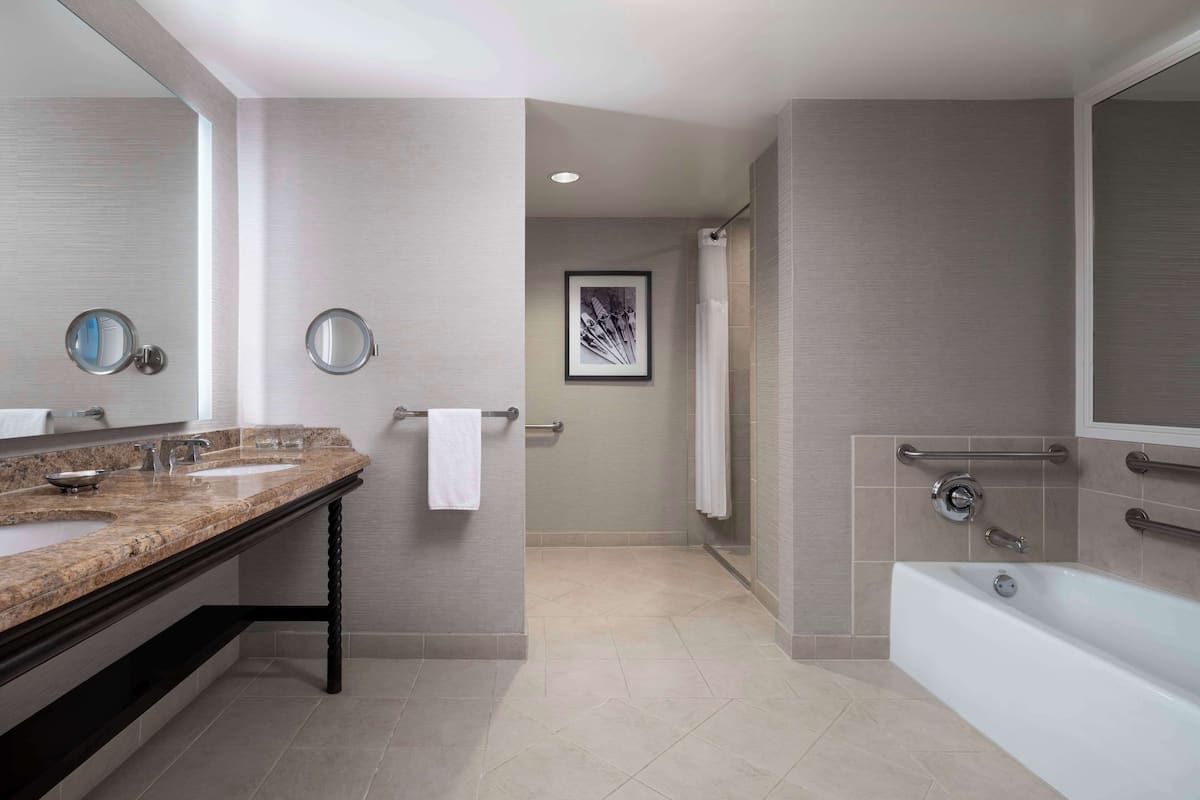 1 King bed, Accessible (Shower) | Bathroom | Combined shower/tub, designer toiletries, hair dryer, bathrobes