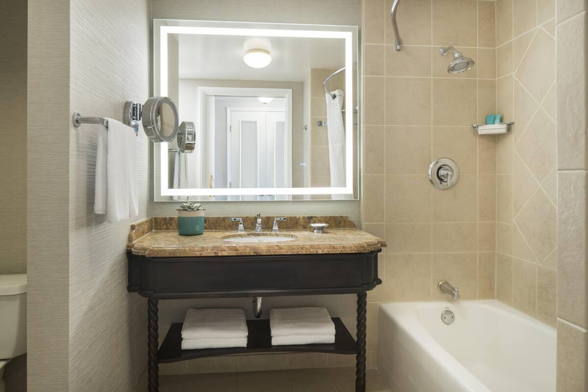 Combined shower/bathtub, designer toiletries, hair dryer, bathrobes