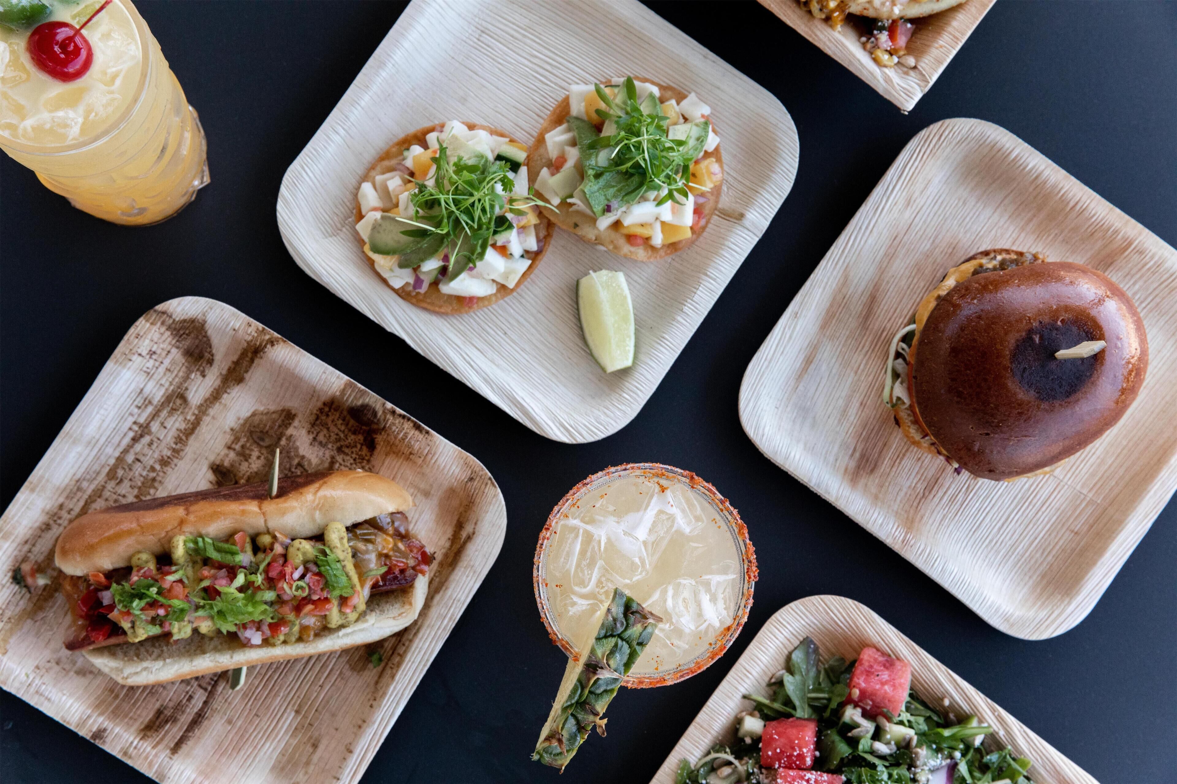 A variety of food items on wooden serving boards.