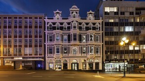 A historic building with a classic architectural style, featuring multiple stories, large windows, and a prominent entrance. - Fable Dunedin (Dunedin)