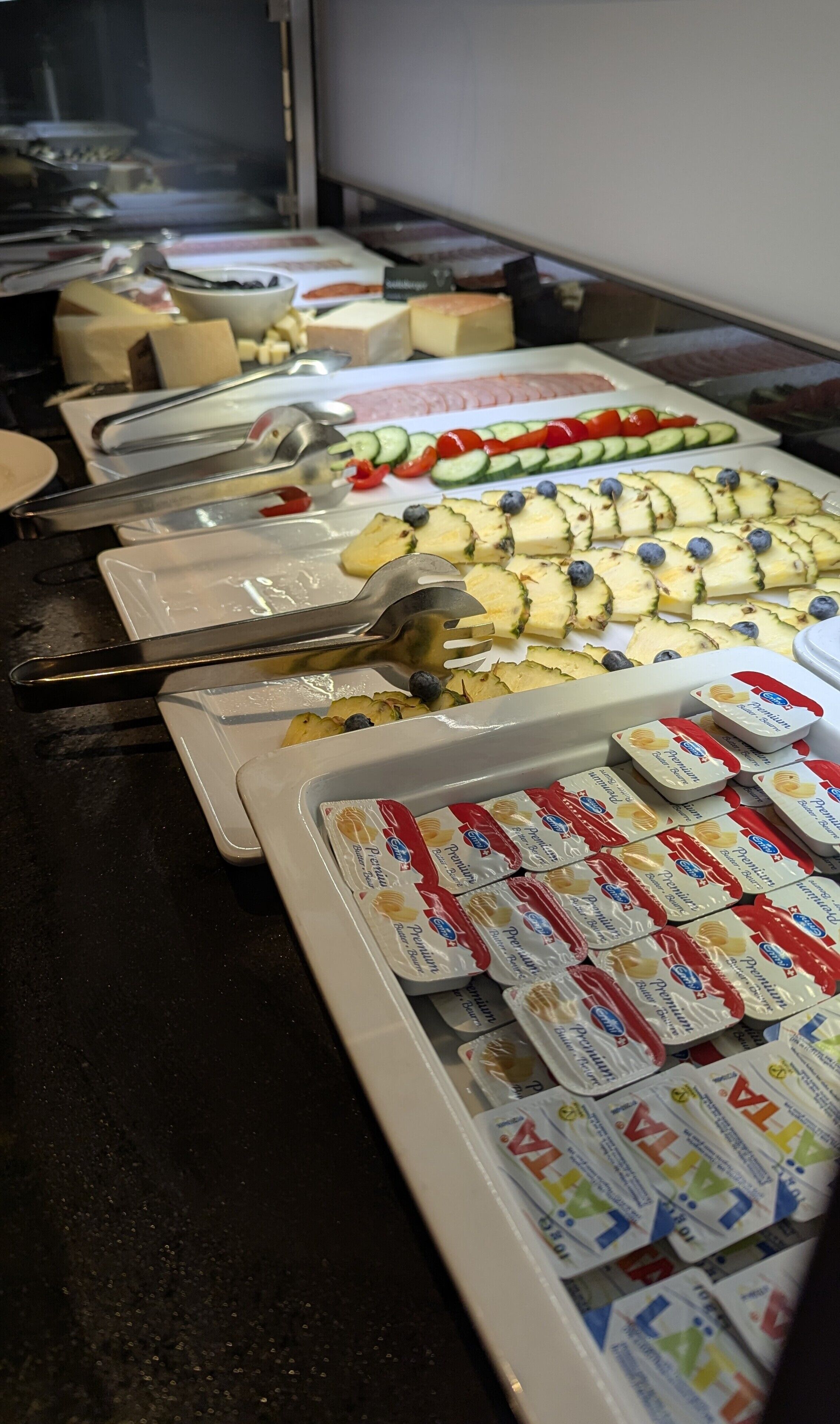 A buffet with various food items and condiments.