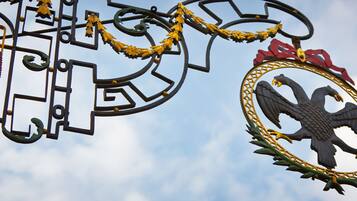 A metal gate with a decorative emblem featuring an eagle and a wreath.